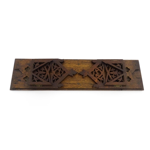 1340 - A Victorian oak extending bookslide / book holder with Gothic fretwork decoration. Approx. 22