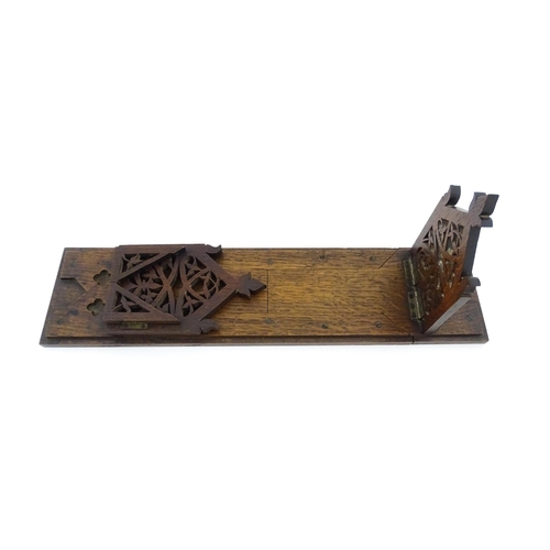 1340 - A Victorian oak extending bookslide / book holder with Gothic fretwork decoration. Approx. 22