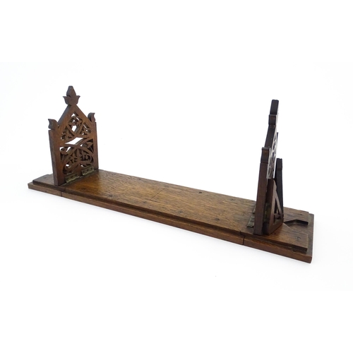 1340 - A Victorian oak extending bookslide / book holder with Gothic fretwork decoration. Approx. 22