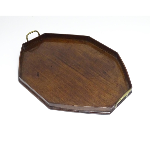 1352 - A late 19th / early 20thC mahogany tray of octagonal form with twin handles. Approx. 21 1/4