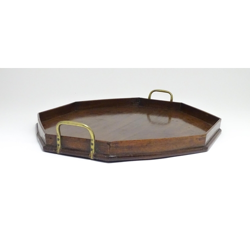 1352 - A late 19th / early 20thC mahogany tray of octagonal form with twin handles. Approx. 21 1/4