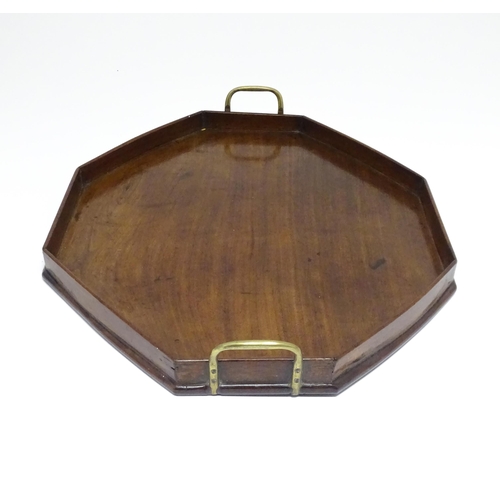 1352 - A late 19th / early 20thC mahogany tray of octagonal form with twin handles. Approx. 21 1/4