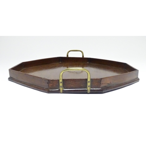 1352 - A late 19th / early 20thC mahogany tray of octagonal form with twin handles. Approx. 21 1/4