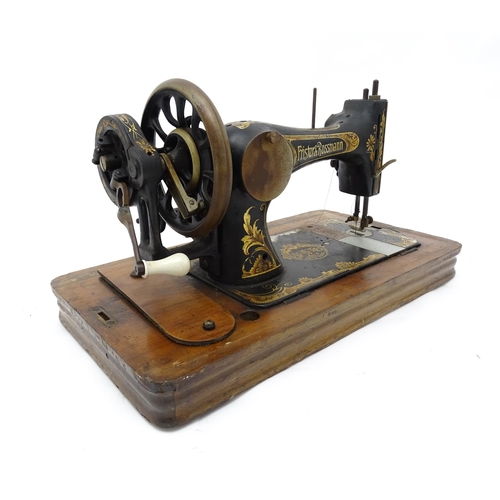 1354 - An early 20thC Frister & Rossmann hand crank sewing machine with floral and foliate decoration. The ... 