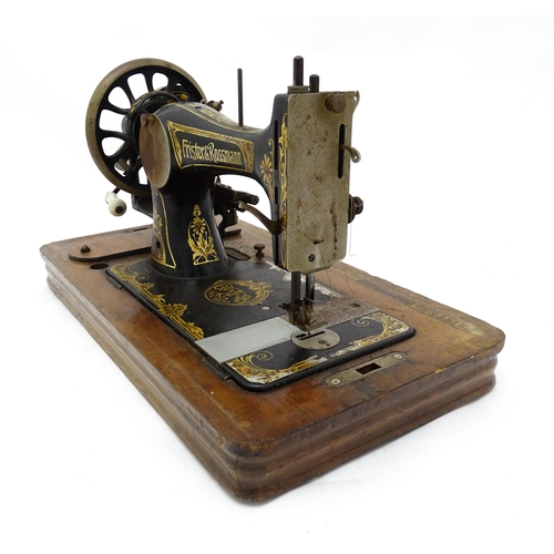 1354 - An early 20thC Frister & Rossmann hand crank sewing machine with floral and foliate decoration. The ... 