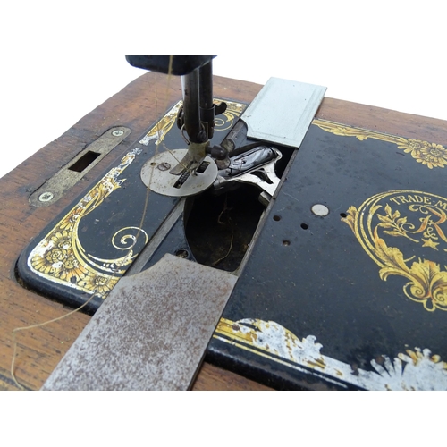 1354 - An early 20thC Frister & Rossmann hand crank sewing machine with floral and foliate decoration. The ... 