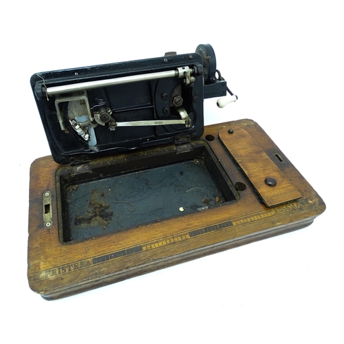 1354 - An early 20thC Frister & Rossmann hand crank sewing machine with floral and foliate decoration. The ... 