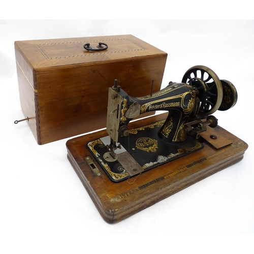 1354 - An early 20thC Frister & Rossmann hand crank sewing machine with floral and foliate decoration. The ... 