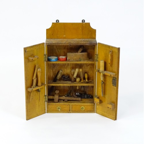 1355 - An early / mid 20thC wall hanging work box , containing carpentry / woodworking tools to include spo... 