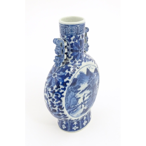 1 - A Chinese blue and white moon flask vase with twin foliate handles, decorated with central vignettes... 