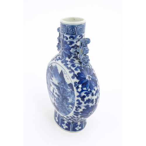 1 - A Chinese blue and white moon flask vase with twin foliate handles, decorated with central vignettes... 