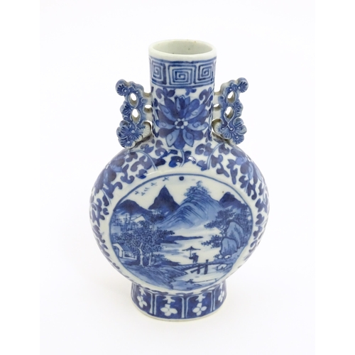 1 - A Chinese blue and white moon flask vase with twin foliate handles, decorated with central vignettes... 