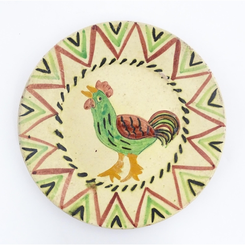 103 - A Portuguese earthenware plate with cockerel / rooster decoration. Incised Redondo to reverse Approx... 