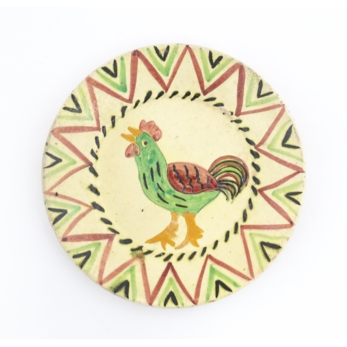 103 - A Portuguese earthenware plate with cockerel / rooster decoration. Incised Redondo to reverse Approx... 