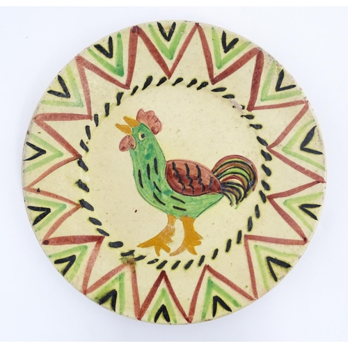 103 - A Portuguese earthenware plate with cockerel / rooster decoration. Incised Redondo to reverse Approx... 