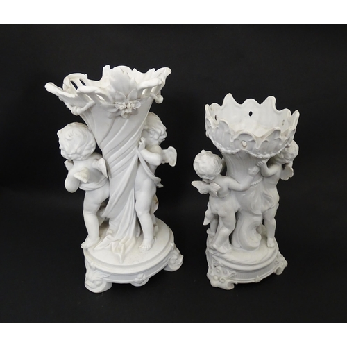 108 - Two bisque vases of cornucopia form with cherub / putti and swag detail. Largest approx. 10