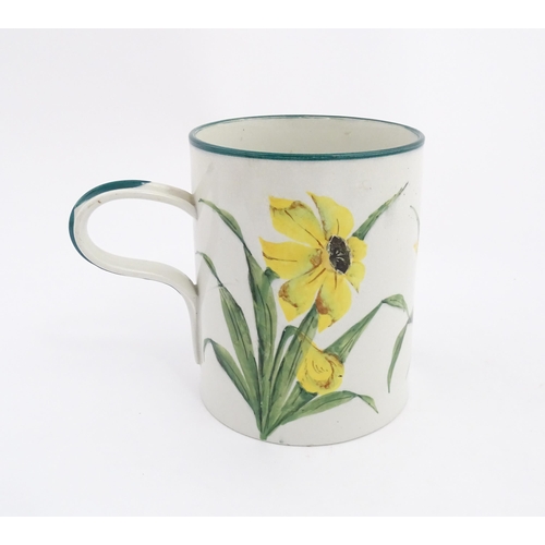 115 - A Wemyss tankard / mug with hand painted daffodil flowers and green detail to rim and handle. Impres... 