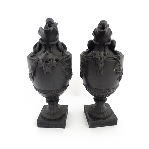 118 - A pair of Wedgwood black basalt wine and water ewers, the wine ewer Sacred to Bacchus, with seated B... 