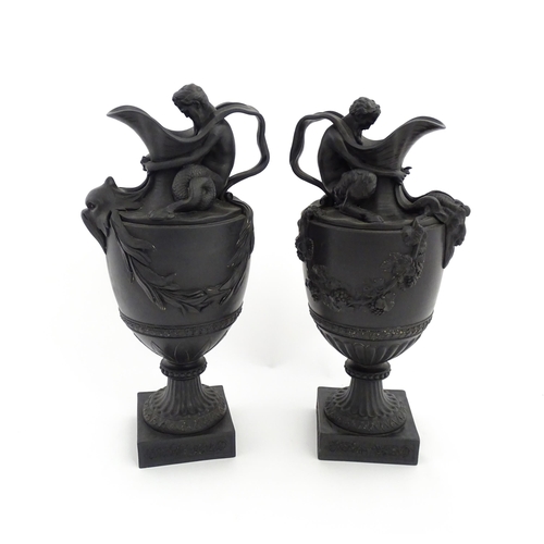 118 - A pair of Wedgwood black basalt wine and water ewers, the wine ewer Sacred to Bacchus, with seated B... 