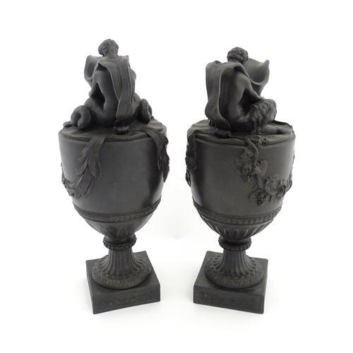 118 - A pair of Wedgwood black basalt wine and water ewers, the wine ewer Sacred to Bacchus, with seated B... 