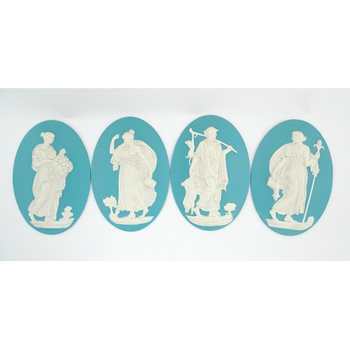 121 - Four Wedgwood Jasperware style plaques of oval form depicting Classical ladies. Approx. 12 1/2