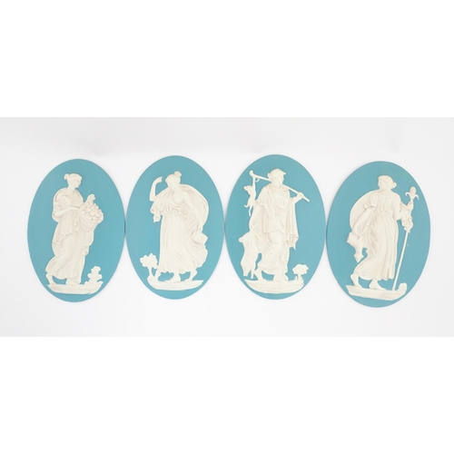 121 - Four Wedgwood Jasperware style plaques of oval form depicting Classical ladies. Approx. 12 1/2