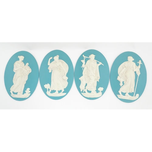 121 - Four Wedgwood Jasperware style plaques of oval form depicting Classical ladies. Approx. 12 1/2