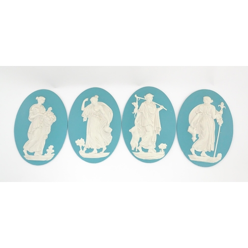 121 - Four Wedgwood Jasperware style plaques of oval form depicting Classical ladies. Approx. 12 1/2