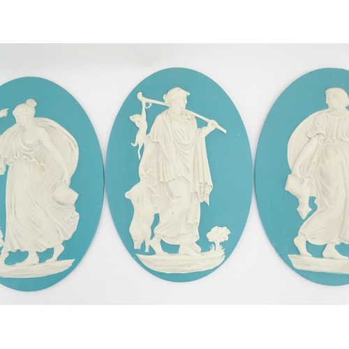 121 - Four Wedgwood Jasperware style plaques of oval form depicting Classical ladies. Approx. 12 1/2