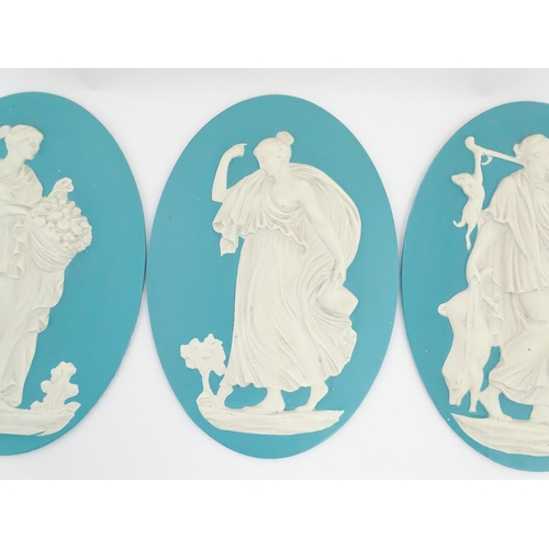 121 - Four Wedgwood Jasperware style plaques of oval form depicting Classical ladies. Approx. 12 1/2