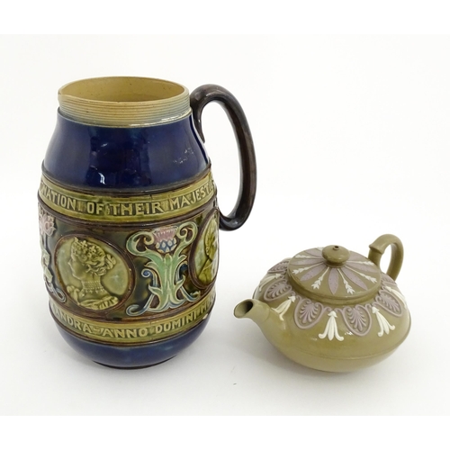 123 - A small Wedgwood stoneware teapot with relief banded decoration. Together with a Doulton Lambeth jug... 