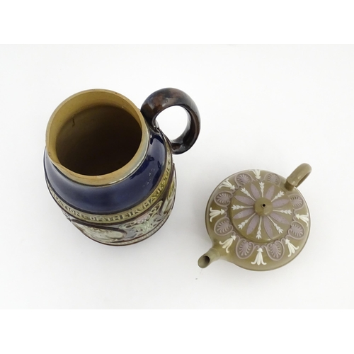 123 - A small Wedgwood stoneware teapot with relief banded decoration. Together with a Doulton Lambeth jug... 