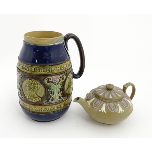 123 - A small Wedgwood stoneware teapot with relief banded decoration. Together with a Doulton Lambeth jug... 