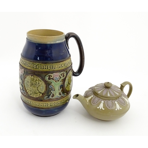 123 - A small Wedgwood stoneware teapot with relief banded decoration. Together with a Doulton Lambeth jug... 