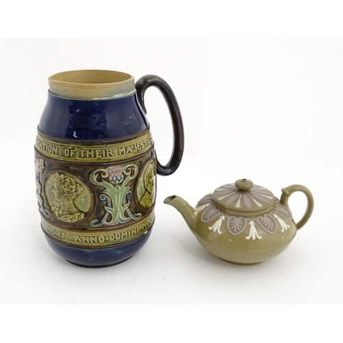 123 - A small Wedgwood stoneware teapot with relief banded decoration. Together with a Doulton Lambeth jug... 