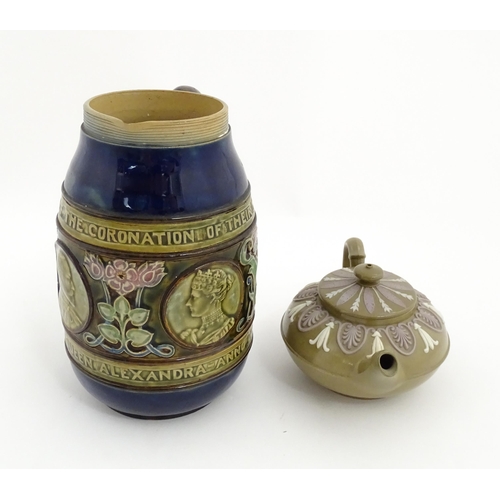 123 - A small Wedgwood stoneware teapot with relief banded decoration. Together with a Doulton Lambeth jug... 