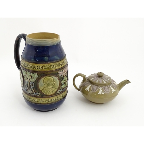 123 - A small Wedgwood stoneware teapot with relief banded decoration. Together with a Doulton Lambeth jug... 