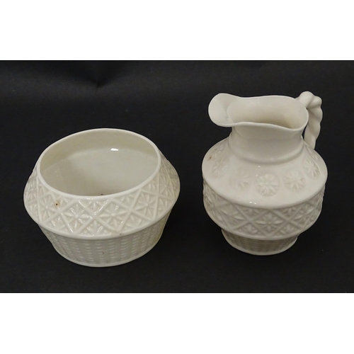 124 - A Belleek sugar bowl and milk jug with banded decoration. Marked under. Jug approx. 3 1/2