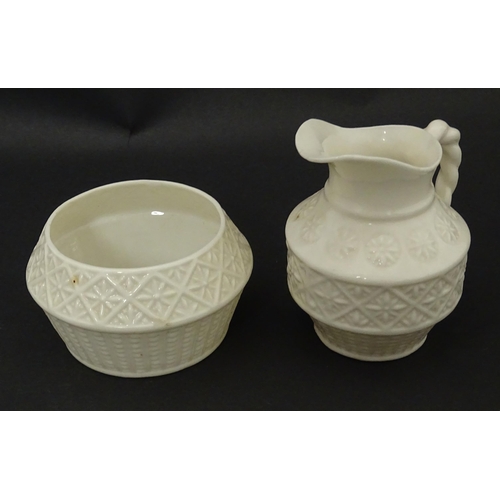 124 - A Belleek sugar bowl and milk jug with banded decoration. Marked under. Jug approx. 3 1/2