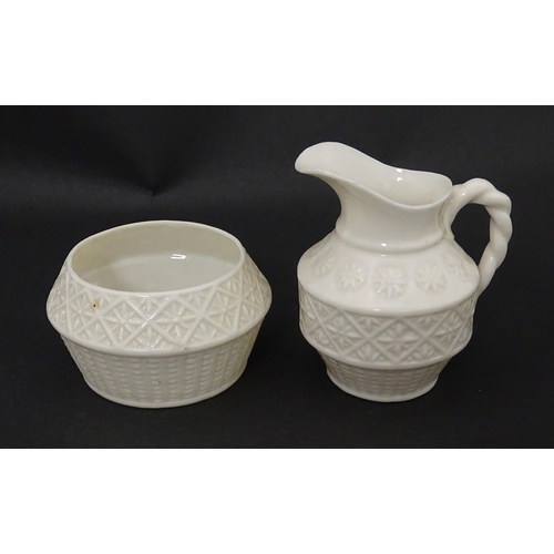 124 - A Belleek sugar bowl and milk jug with banded decoration. Marked under. Jug approx. 3 1/2