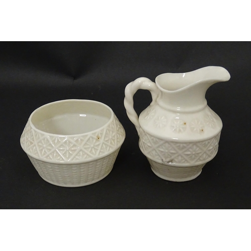 124 - A Belleek sugar bowl and milk jug with banded decoration. Marked under. Jug approx. 3 1/2