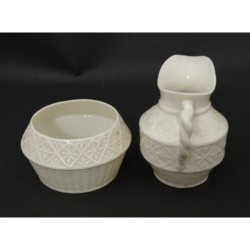 124 - A Belleek sugar bowl and milk jug with banded decoration. Marked under. Jug approx. 3 1/2