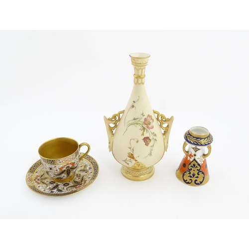 128 - A Royal Worcester blush ivory vase with twin handles of shaped form decorated with flowers and folia... 