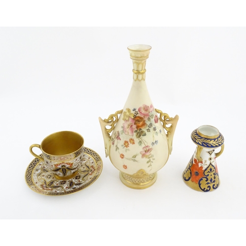 128 - A Royal Worcester blush ivory vase with twin handles of shaped form decorated with flowers and folia... 