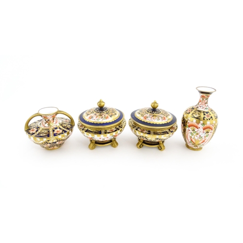 129 - Four items of Royal Crown Derby decorated in the Imari palette comprising a pair of lidded pots of u... 