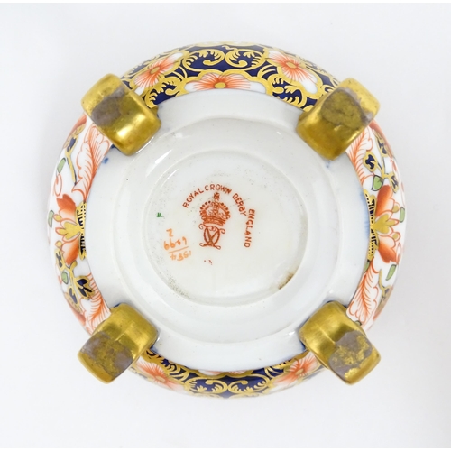 129 - Four items of Royal Crown Derby decorated in the Imari palette comprising a pair of lidded pots of u... 