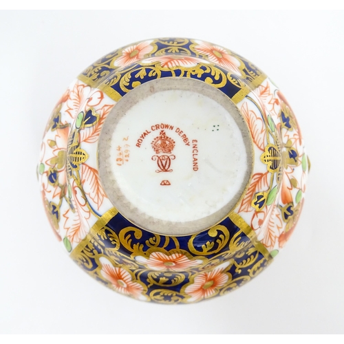 129 - Four items of Royal Crown Derby decorated in the Imari palette comprising a pair of lidded pots of u... 