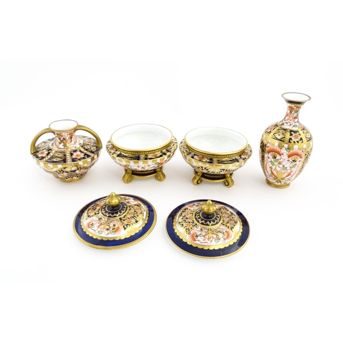 129 - Four items of Royal Crown Derby decorated in the Imari palette comprising a pair of lidded pots of u... 