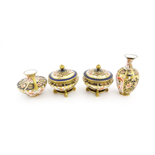 129 - Four items of Royal Crown Derby decorated in the Imari palette comprising a pair of lidded pots of u... 