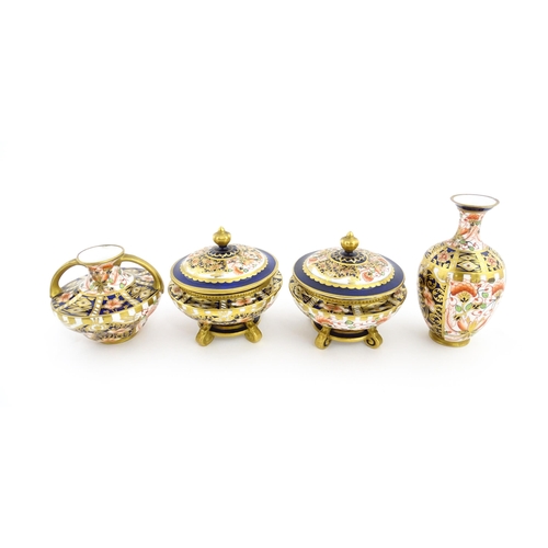 129 - Four items of Royal Crown Derby decorated in the Imari palette comprising a pair of lidded pots of u... 